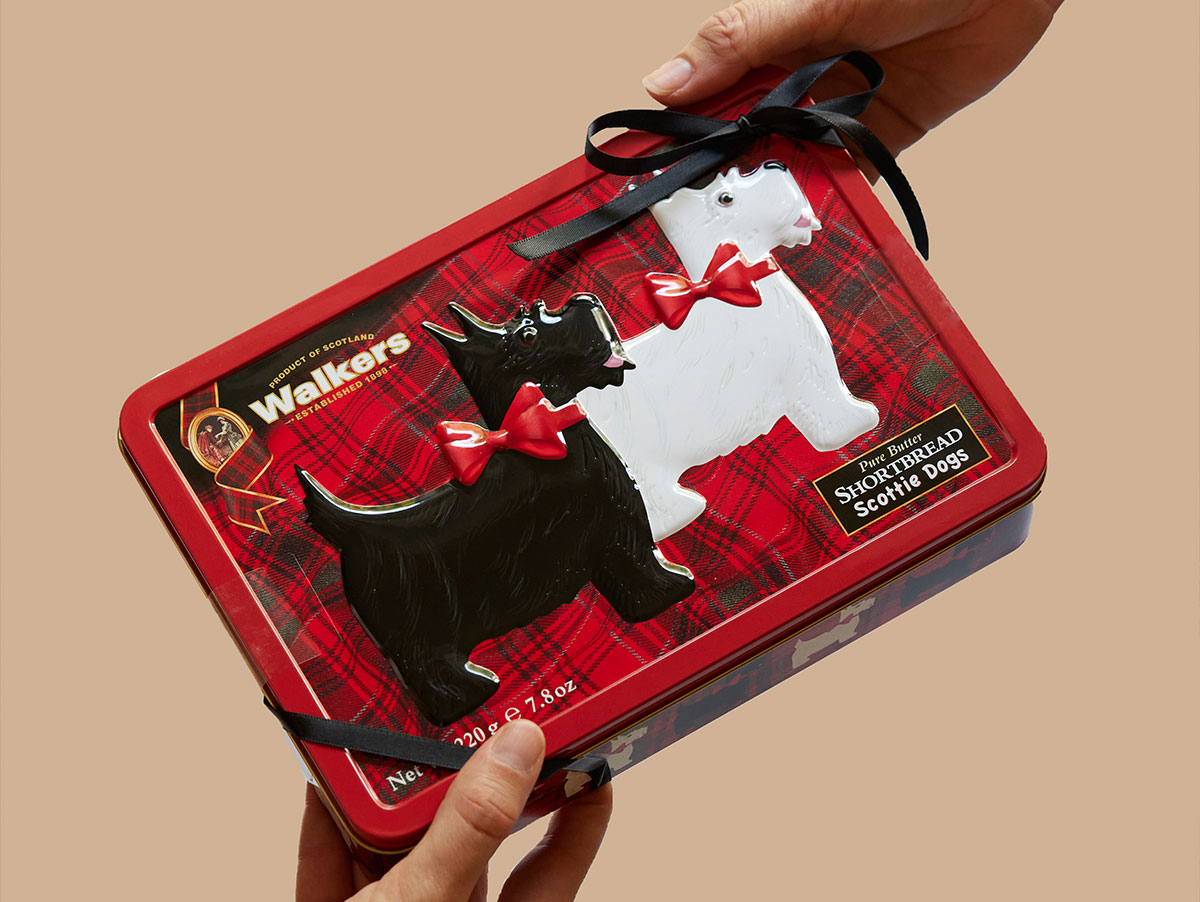 A tin of Shotbread Scottie Dogs with a black bow